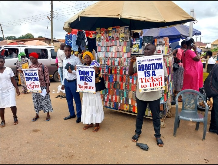 Believers sharing the gospel during a street outreach